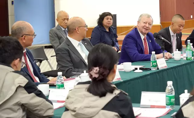 Hong Kong Jockey Club CEO Winfried Engelbrecht-Bresges (2nd right) and other Club representatives listen to master's and doctoral students in disaster nursing share their research results at a seminar at the IDMR.