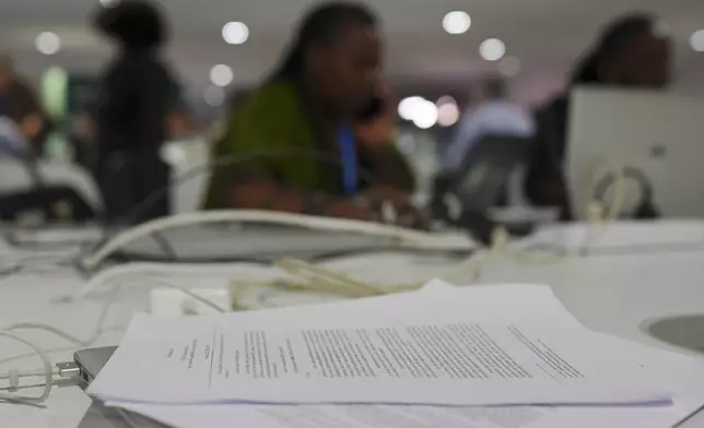 A draft of a proposed deal for curbing climate change sits on a table at the COP29 U.N. Climate Summit, Friday, Nov. 22, 2024, in Baku, Azerbaijan. (AP Photo/Peter Dejong)