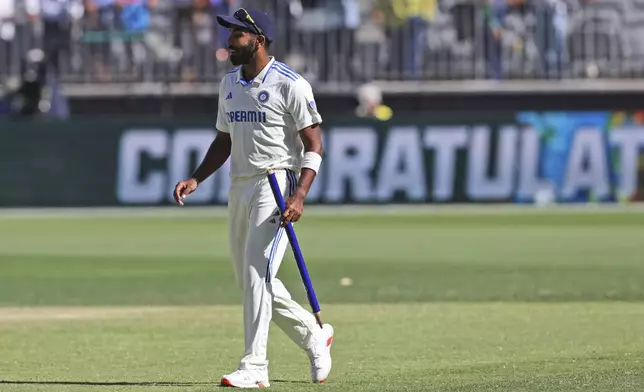 India's captain Jasprit Bumrah leaves the field carrying a stump after winning the first cricket test against Australia in Perth, Australia, Monday, Nov. 25, 2024. (AP Photo/Trevor Collens)