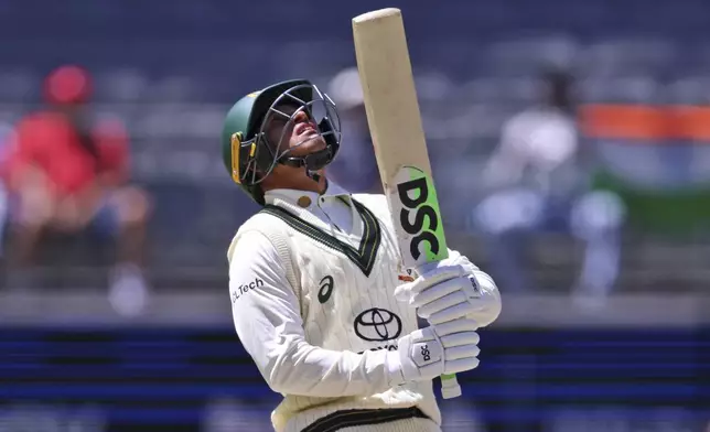 Australia's Usman Khawaja reacts after losing his wicket to India's Mohammed Siraj on the fourth day of the first cricket test between Australia and India in Perth, Australia, Monday, Nov. 25, 2024. (AP Photo/Trevor Collens)