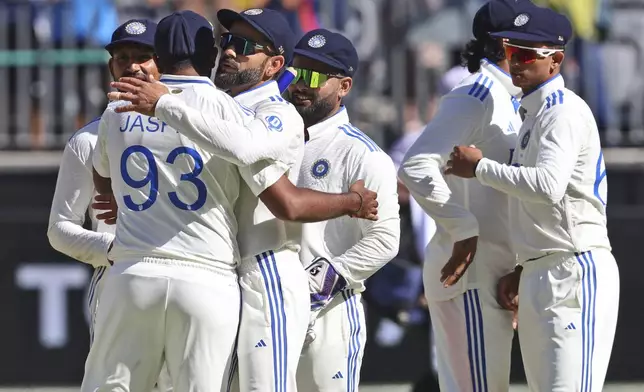 India's captain Jasprit Bumrah hugs teammate Virat Kohli after winning the first cricket test against Australia in Perth, Australia, Monday, Nov. 25, 2024. (AP Photo/Trevor Collens)