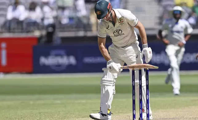 Australia's Mitchell Marsh reacts after losing his wicket on the fourth day of the first cricket test between Australia and India in Perth, Australia, Monday, Nov. 25, 2024. (AP Photo/Trevor Collens)