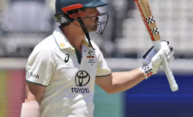 Australia's Travis Head celebrates his fifty runs on the fourth day of the first cricket test between Australia and India in Perth, Australia, Monday, Nov. 25, 2024. (AP Photo/Trevor Collens)