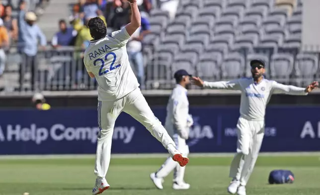 India's Harshit Rana, left, celebrates the wicket of Australia's Alex Carey on the fourth day of the first cricket test between Australia and India in Perth, Australia, Monday, Nov. 25, 2024. (AP Photo/Trevor Collens)