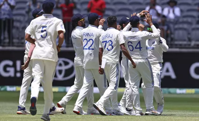 India's players celebrate the wicket of Australia's Steve Smith on the fourth day of the first cricket test between Australia and India in Perth, Australia, Monday, Nov. 25, 2024. (AP Photo/Trevor Collens)