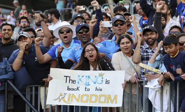 India's fans celebrate after India won the first cricket test against Australia in Perth, Australia, Monday, Nov. 25, 2024. (AP Photo/Trevor Collens)