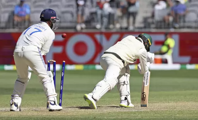 Australia's Nathan Lyon is bowled out by India's Washington Sundar on the fourth day of the first cricket test between Australia and India in Perth, Australia, Monday, Nov. 25, 2024. (AP Photo/Trevor Collens)