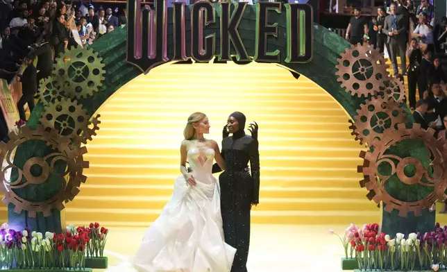 FILE - Cynthia Erivo, right, and Ariana Grande pose for the photographers prior to the the premiere of "Wicked" at Auditorio Nacional in Mexico City, Monday, Nov. 11, 2024. In “Wicked,” Elphaba and Glinda travel from Shiz University to the Emerald City on a glistening green train to meet the wizard. In real life, Cynthia Erivo and Ariana Grande have traveled much farther and wider and longer and on airplanes to promote their hotly anticipated film. (AP Photo/Fernando Llano, File)