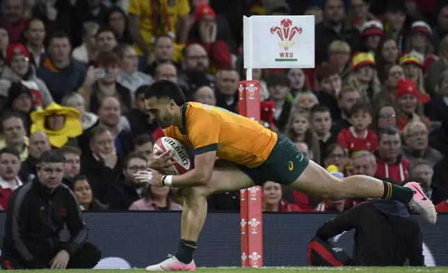 Australia's Tom Wright scores a try during the Autumn Nations series rugby union match between Wales and Australia at the Principality Stadium in Cardiff, Wales, Sunday, Nov. 17, 2024.(AP Photo/Rui Vieira)