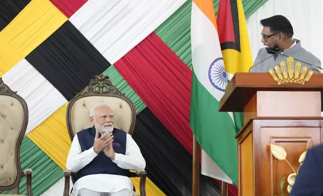 India's Prime Minister Narendra Modi applauds while Guyana's President Mohammed Irfaan Ali takes the podium at Government House in Georgetown, Guyana, Wednesday, Nov. 20, 2024. (AP Photo/Matias Delacroix)