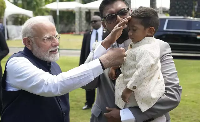 India's Prime Minister Narendra Modi, left, playfully teases Lilan Ali, the son of Guyana's President Mohammed Irfaan Ali, at Government House in Georgetown, Guyana, Wednesday, Nov. 20, 2024. (AP Photo/Matias Delacroix)