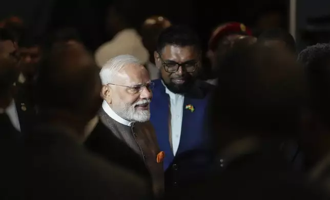 India's Prime Minister Narendra Modi, left, is welcomed by Guyana's President Mohamed Irfaan Ali as he arrives to his hotel in Georgetown, Guyana, Tuesday, Nov. 19, 2024. (AP Photo/Matias Delacroix)