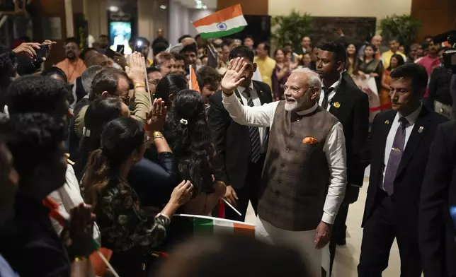 India's Prime Minister Narendra Modi waves to members of Guyana's Hindu community as he arrives from the airport to his hotel in Georgetown, Guyana, Tuesday, Nov. 19, 2024. (AP Photo/Matias Delacroix)