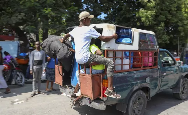 Residents flee their homes to escape gang violence in the Nazon neighborhood of Port-au-Prince, Haiti, Thursday, Nov. 14, 2024. (AP Photo/Odelyn Joseph)