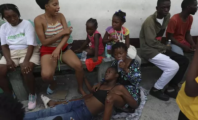 An asthmatic girl rests as she takes refuge in a private school serving as a shelter for residents fleeing gang violence in the Nazon neighborhood, in Port-au-Prince, Haiti, Thursday, Nov. 14, 2024. (AP Photo/Odelyn Joseph)