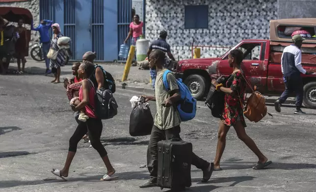 Residents flee their homes to escape gang violence in the Nazon neighborhood of Port-au-Prince, Haiti, Thursday, Nov. 14, 2024. (AP Photo/Odelyn Joseph)