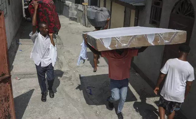 Residents flee their homes to escape gang violence in the Nazon neighborhood of Port-au-Prince, Haiti, Thursday, Nov. 14, 2024. (AP Photo/Odelyn Joseph)