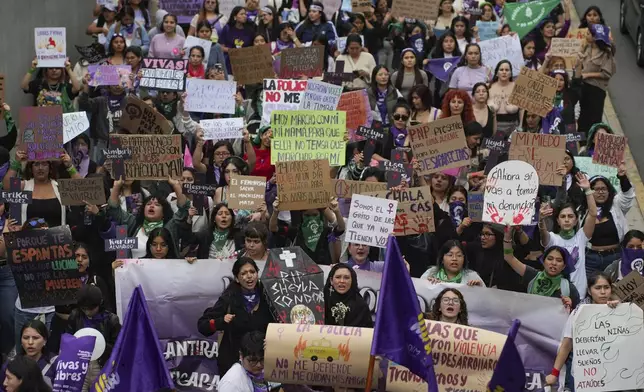 People take part in a march marking the upcoming International Day for the Elimination of Violence Against Women, in Lima, Peru, Saturday, Nov. 23, 2024. (AP Photo/Guadalupe Pardo)