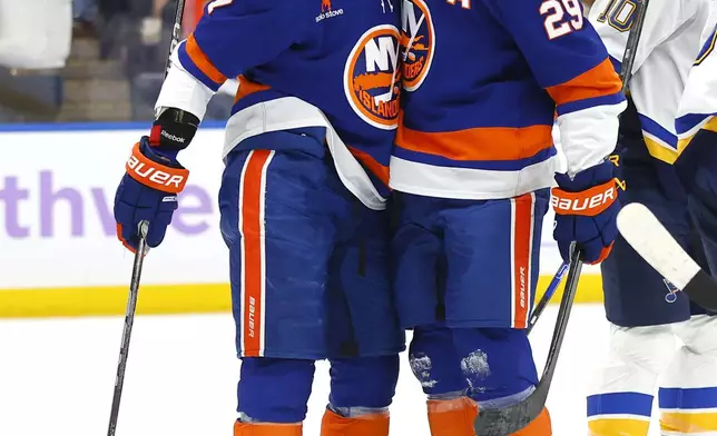 New York Islanders center Brock Nelson (29) celebrates with right wing Maxim Tsyplakov (7) after scoring a goal against the St. Louis Blues during the second period of an NHL hockey game, Saturday, Nov. 23, 2024, in New York. (AP Photo/Noah K. Murray)