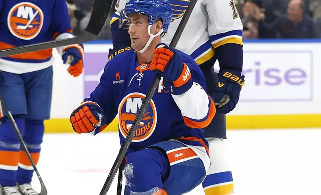 New York Islanders center Brock Nelson (29) reacts after scoring a goal in front of St. Louis Blues center Brayden Schenn (10) during the second period of an NHL hockey game, Saturday, Nov. 23, 2024, in New York. (AP Photo/Noah K. Murray)