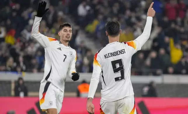 Germany's Tim Kleindienst celebrates with Kai Havertz after scoring his side's seventh goal during the Nations League group soccer match between Germany and Bosnia in Freiburg, Germany, Saturday, Nov. 16, 2024. (AP Photo/Michael Probst)