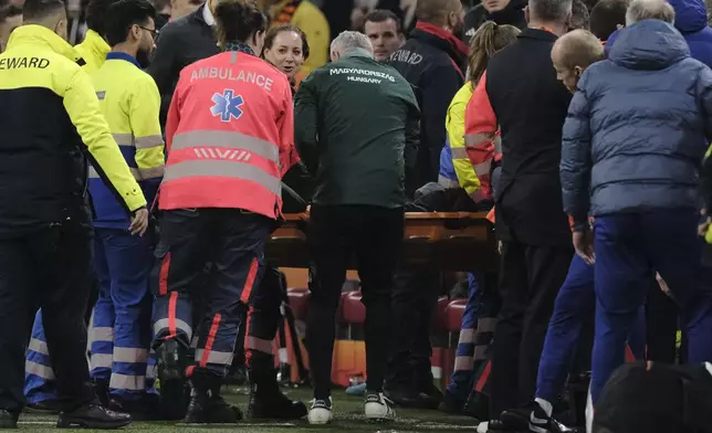 Medics carry Hungary's assistant coach Adam Szalai from the pitch during the UEFA Nations League soccer match between Netherlands and Hungary, at the Johan Cruyff ArenA, in Amsterdam, Netherlands, Saturday, Nov. 16, 2024. (AP Photo/Patrick Post)