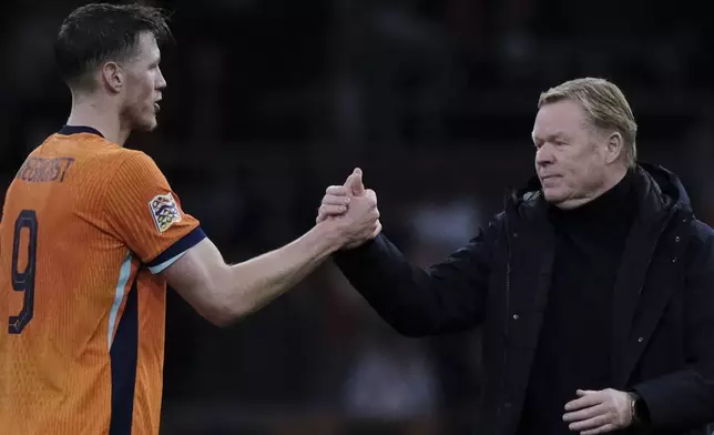 Ronald Koeman, head coach of the Netherlands, right shakes hands with Wout Weghorst of the Netherlands at the end of the UEFA Nations League soccer match between Netherlands and Hungary, at the Johan Cruyff ArenA, in Amsterdam, Netherlands, Saturday, Nov. 16, 2024. (AP Photo/Patrick Post)