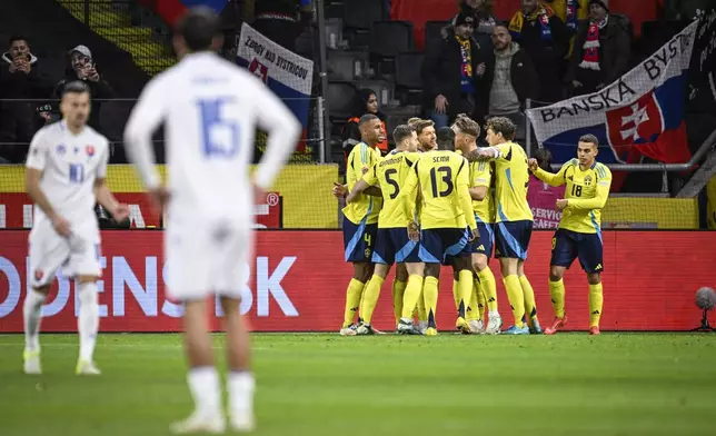 Sweden's Viktor Gyökeres, 17, celebrates with his teammates after scoring their side's first goal during the UEFA Nations League group C1 soccer match between Sweden and Slovakia at Strawberry Arena in Stockholm, Sweden, Saturday Nov. 16, 2024. (Pontus Lundahl/TT News Agency via AP)