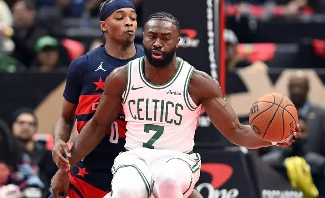 Boston Celtics guard Jaylen Brown (7) makes a one on Washington Wizards guard Bilal Coulibaly during the first half of an NBA basketball game Friday, Nov. 22, 2024, in Washington. (AP Photo/John McDonnell)