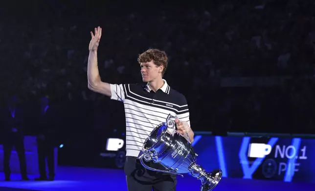 Italy's Jannik Sinner holds the trophy as ATP world best player at the ATP World Tour Finals at the Inalpi Arena, in Turin, Italy, Monday, Nov. 11, 2024. Sinner was presented with the trophy for finishing the year ranked No. 1. (AP Photo/Antonio Calanni)