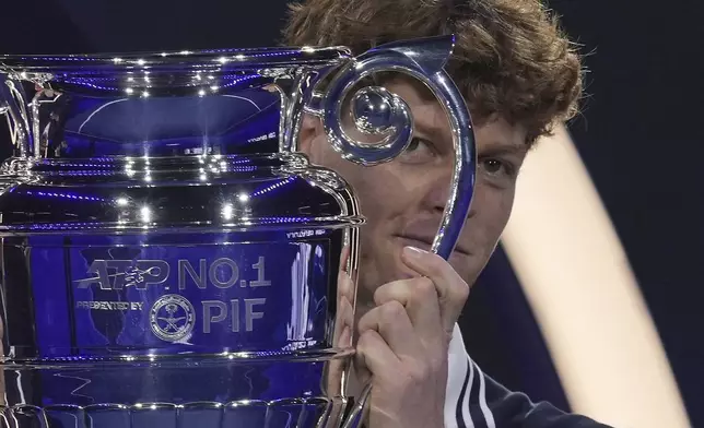 Italy's Jannik Sinner holds the trophy as ATP world best player at the ATP World Tour Finals at the Inalpi Arena, in Turin, Italy, Monday, Nov. 11, 2024. Sinner was presented with the trophy for finishing the year ranked No. 1. (AP Photo/Antonio Calanni)