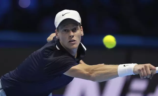 Italy's Jannik Sinner returns the ball to United States' Taylor Fritz during their singles tennis match of the ATP World Tour Finals at the Inalpi Arena, in Turin, Italy, Tuesday, Nov. 12, 2024. (AP Photo/Antonio Calanni)