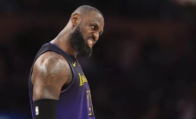 Los Angeles Lakers forward LeBron James reacts after scoring during the second half of an NBA basketball game against the Orlando Magic, Thursday, Nov. 21, 2024, in Los Angeles. (AP Photo/Mark J. Terrill)