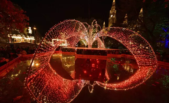 Illuminations of the Wiener Chritkindlmarkt in front of Vienna's city hall, one of Vienna's most popular Christmas markets, in Vienna, Austria, Saturday, Nov. 16, 2024. (AP Photo/Christian Bruna)