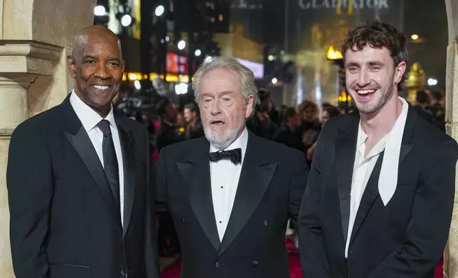 Denzel Washington, from left, director Ridley Scott, left, and Paul Mescal pose for photographers upon arrival at the premiere of the film 'Gladiator II' on Wednesday, Nov. 13, 2024, in London. (Photo by Scott A Garfitt/Invision/AP)