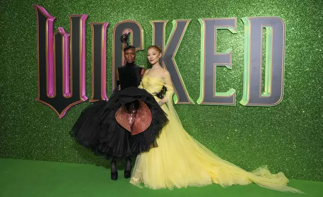 Cynthia Erivo, left, and Ariana Grande pose for photographers upon arrival at the premiere of the film 'Wicked' on Monday, Nov. 18, 2024, in London. (Photo by Scott A Garfitt/Invision/AP)