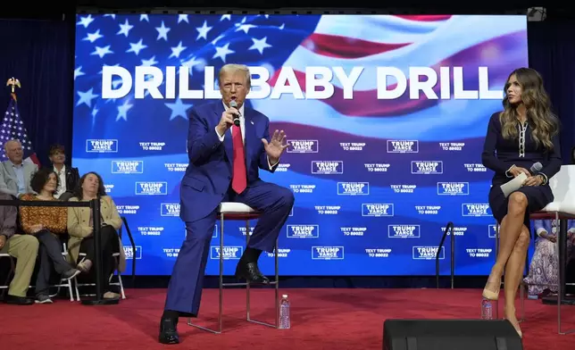 FILE - Republican presidential nominee former President Donald Trump speaks at a campaign town hall at the Greater Philadelphia Expo Center &amp; Fairgrounds, Oct. 14, 2024, in Oaks, Pa., as moderator South Dakota Gov. Kristi Noem listens. (AP Photo/Alex Brandon)