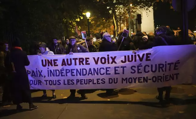 Protestors take part in a rally against the "Israel is Forever" gala organized by far-right Franco-Israeli figures, in Paris, Wednesday, Nov. 13, 2024, on the eve of the UEFA Nations League 2025 soccer match between France and Israel. Banner reads " Another jewish voice. Peace, independence and security for all the peoples of the middle east". (AP Photo/Christophe Ena)