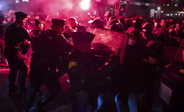 Protesters and police clash during a rally against the "Israel is Forever" gala organized by far-right Franco-Israeli figures, in Paris, Wednesday, Nov. 13, 2024, on the eve of the UEFA Nations League 2025 soccer match between France and Israel. (AP Photo/Louise Delmotte)