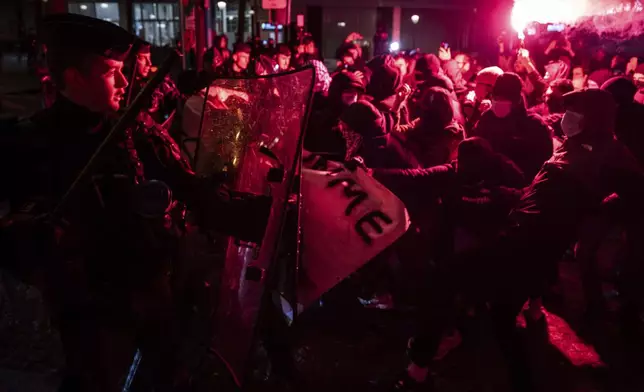 Protesters and police clash during a rally against the "Israel is Forever" gala organized by far-right Franco-Israeli figures, in Paris, Wednesday, Nov. 13, 2024, on the eve of the UEFA Nations League 2025 soccer match between France and Israel. (AP Photo/Louise Delmotte)