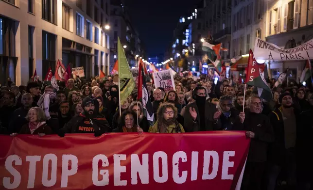 Protesters take part in a rally against the "Israel is Forever" gala organized by far-right Franco-Israeli figures, in Paris, Wednesday, Nov. 13, 2024, on the eve of the UEFA Nations League 2025 soccer match between France and Israel. (AP Photo/Louise Delmotte)