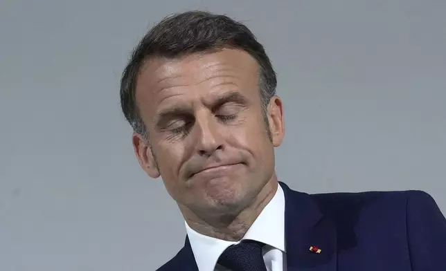 FILE - French President Emmanuel Macron reacts as he delivers a speech, Wednesday, June 12, 2024 in Paris. (AP Photo/Michel Euler, file)