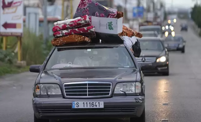 People in their cars with belongings return back to their villages after a ceasefire between Hezbollah and Israel began early morning, in Tyre, south Lebanon, Wednesday, Nov. 27, 2024. (AP Photo/Hussein Malla)