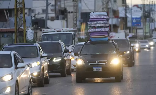 People in their cars return back to their villages after the ceasefire between Hezbollah and Israel began early morning, in Tyre, south Lebanon, Wednesday, Nov. 27, 2024. (AP Photo/Hussein Malla)