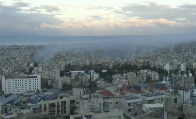 In this image made from video, smoke is seen amid buildings in Beirut, Lebanon, Wednesday, Nov. 27, 2024. (AP Photo)