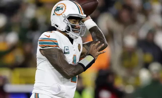 Miami Dolphins quarterback Tua Tagovailoa throws a pass during the first half of an NFL football game against the Green Bay Packers Thursday, Nov. 28, 2024, in Green Bay, Wis. (AP Photo/Matt Ludtke)