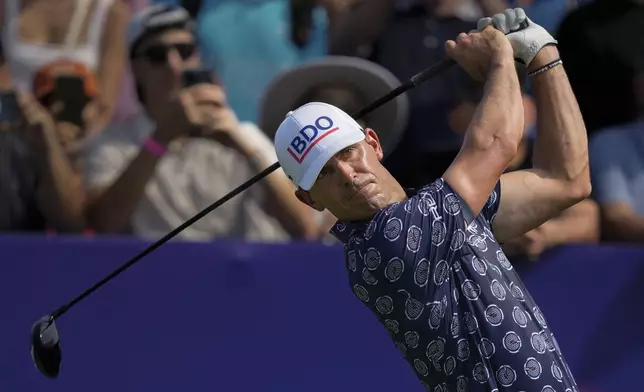 Billy Horschel of the United States hits off the first tee during the first round of World Tour Golf Championship in Dubai, United Arab Emirates, Thursday, Nov. 14, 2024. (AP Photo/Altaf Qadri)