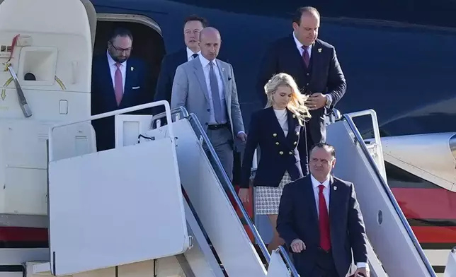 From l-r., Jason Miller, Elon Musk, Stephen Miller, Boris Esphteyn, Natalie Harp and Dan Scavino, walk off President-elect Donald Trump's as he arrives, Wednesday, Nov. 13, 2024, at Andrews Air Force Base, Md. (AP Photo/Alex Brandon)