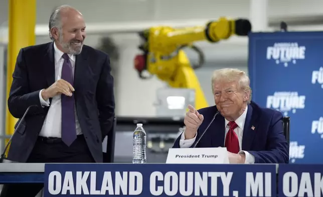 FILE - Republican presidential nominee former President Donald Trump arrives for a roundtable, accompanied by Howard Lutnick, CEO of Cantor Fitzgerald, in Auburn Hills, Mich., Oct. 18, 2024. (AP Photo/Evan Vucci, File)