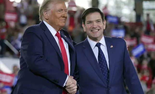 FILE - Republican presidential nominee former President Donald Trump greets Sen. Marco Rubio, R-Fla., during a campaign rally at J.S. Dorton Arena, Nov. 4, 2024, in Raleigh, N.C. (AP Photo/Evan Vucci, File)